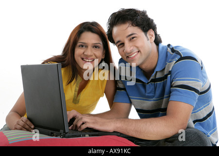 Portrait of a couple using a laptop and smiling Stock Photo
