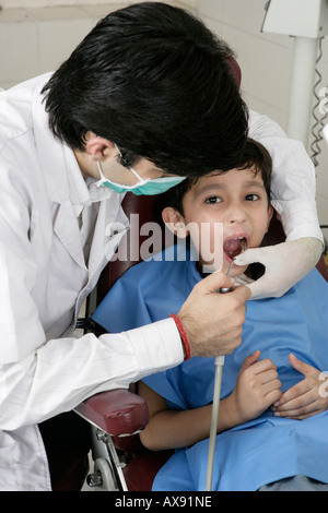 Dentist examining a boy Stock Photo