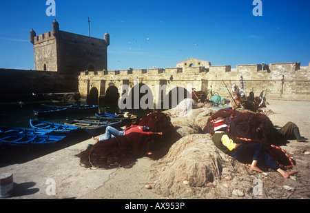 Two men resting on fishing nets a the Port du Skala,  Essaouira, morocco Stock Photo