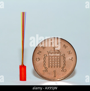 Optical fibres beside penny for scale Stock Photo