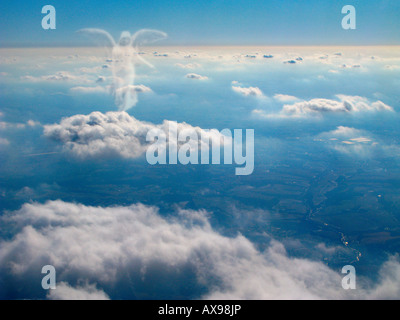 Spirit of an angel walks on top of the clouds. Stock Photo