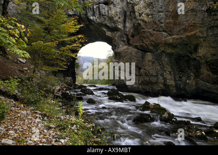 A river runs throu natural bridge in Rakov Skocjan. Stock Photo