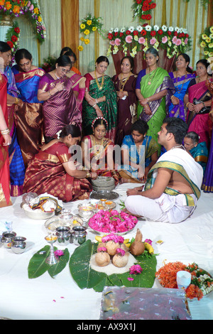 Female guests and family dressed in colourful sarees at a traditional south Indian Hindu wedding ceremony in Hyderabad, Telangana, India. Stock Photo