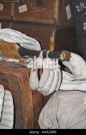 Old leather suitcases and cricket pads Stock Photo
