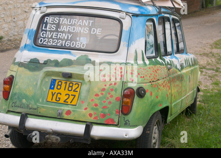 An old Renault station wagon on Rue Claude Monet serves as a colorful advertisement for a restaurant in Giverny, France Stock Photo