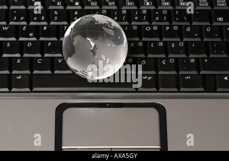 conceptual image on communication showing a glass globe on a laptop Stock Photo