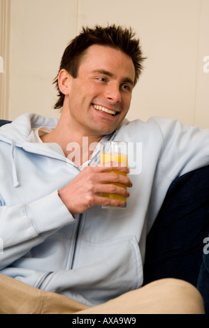 man drinking fresh orange juice Stock Photo
