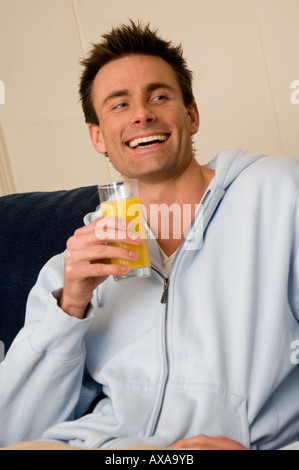 man drinking fresh orange juice Stock Photo