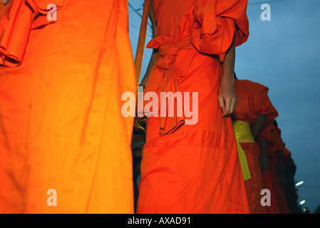 Monks in line receive daily rice and food from townspeople and tourists Luang Prabang Laos Stock Photo