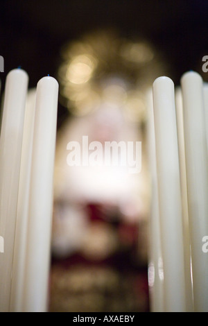 Candles on a Holy Week float with the blurred image of the Virgin on the background, Seville, Spain Stock Photo