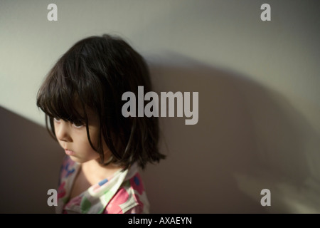 Little girl in beam of light four years old Stock Photo