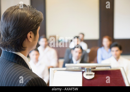 Side profile of a businessman giving presentation in a conference room Stock Photo