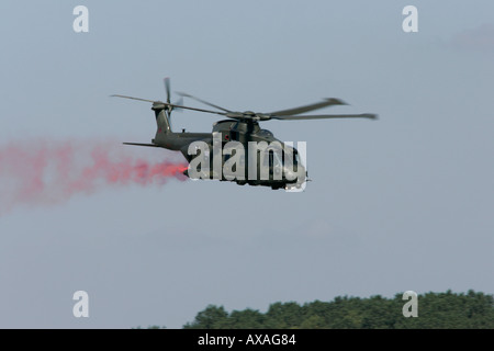 RAF Merlin HC3 trailling red smoke RIAT 2005 RAF Fairford Gloucestershire England UK Stock Photo