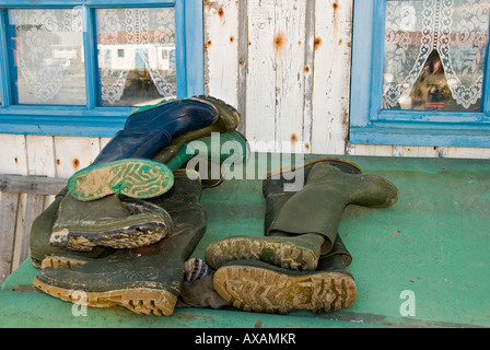 Rubber boots in front of a fishing hut Stock Photo
