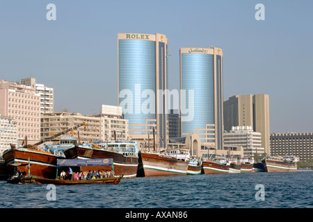 A view along the Dubai creek showing the embankment buildings as well as boats and ferries. Stock Photo