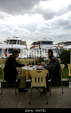 Besiktas quay two men at cafe with Turkish tea Istanbul Turkey Stock Photo