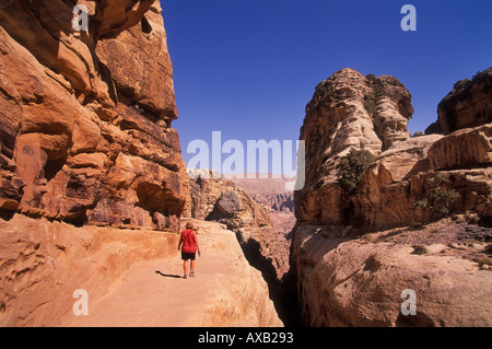 A female tourist walking to the High Place Petra Jordan Middle East Stock Photo