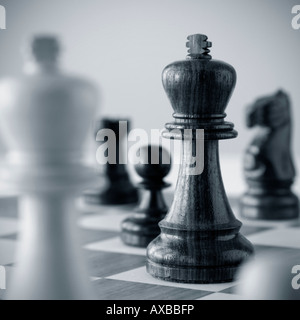 Traditional wooden chess game pieces on board. Stock Photo
