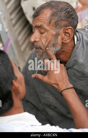 Man with a barber, street, Jaipur, India Stock Photo