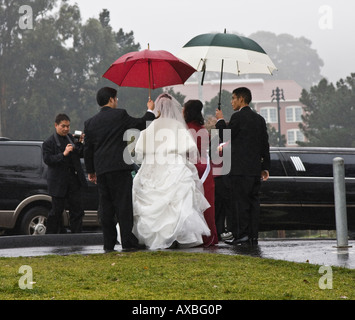 Wedding photo of a Asian American couple on rainy day in San Francisco Stock Photo