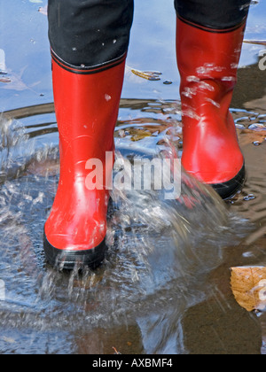 MR legs in rubber boots in a puddle Stock Photo