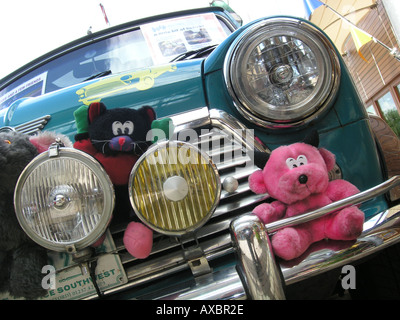 front detail of blue Mini with cuddly toys behind front bumper Stock Photo