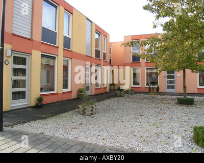 red pink yellow row of terraced houses in Almere Buiten Netherlands Stock Photo