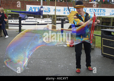 comedy clown giant bubble blower balloon creator Stock Photo