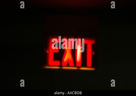 Red Exit sign with dark building interior. Taken with a toy camera for ethereal effect. Stock Photo