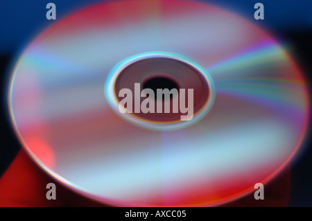 Computer disc in hand with red and blue saturated colors Stock Photo