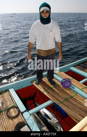 Omani fisherman displaying his catch of yellow-fin tuna on his boat in the Gulf of Oman off the coast of Muscat in Oman. Stock Photo