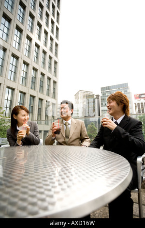 Three business people drinking coffee Stock Photo