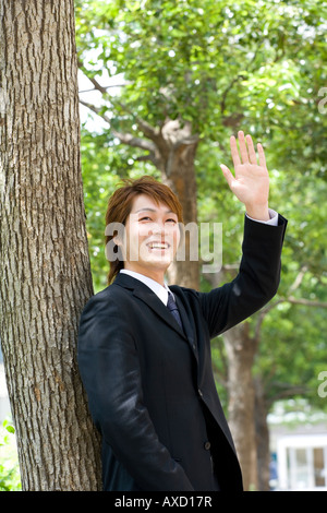 Young businessman waving hand Stock Photo