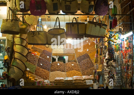 Horizontal close up of mounds of dried apricots, dates, figs, nuts and spices for sale in the souk. Stock Photo