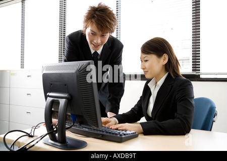 Young man and woman working in office Stock Photo