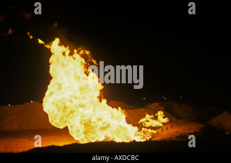 Flaring off waste gas in the desert near Dahran Saudi Arabia Stock Photo