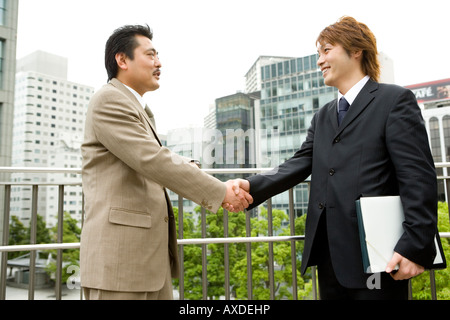 Two businessmen shaking hands Stock Photo