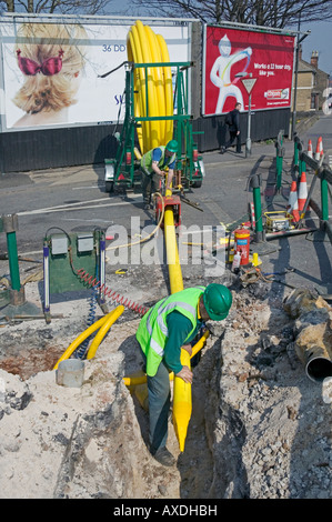 Rehabilitating a city's natural gas supply by replacing deteriorating Victorian cast iron pipes with modern polyethylene tubing. Stock Photo