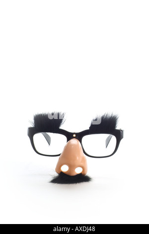 'Humour concept' glasses with mustache eyebrows on a white background. Groucho Marx style glasses. Disguise and funny costume. Stock Photo