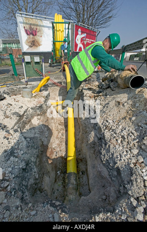 Rehabilitating a city's natural gas supply by replacing deteriorating Victorian cast iron pipes with modern polyethylene tubing. Stock Photo