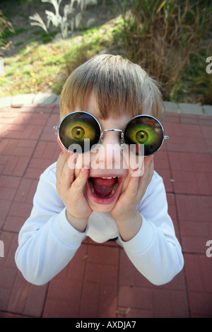 Stock photo of a child wearing holographic glasses with eyes. Silly, funny humor and surprise concepts