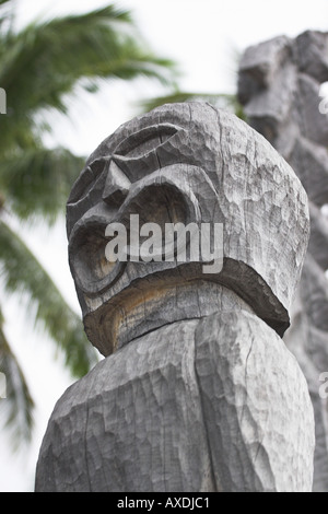 Oh No! Face carved into wood weathered to a light grey on the totem poles Stock Photo
