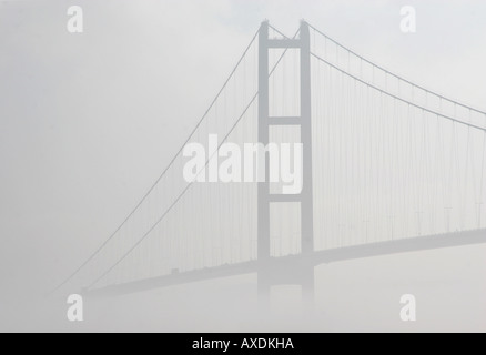 The Humber Bridge in heavy mist from the north bank of the river at Hessel near Hull. Stock Photo