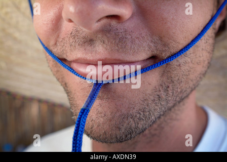 close-up of a man wearing a straw hat Stock Photo