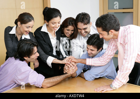 Group of business people arms wrestling in an office Stock Photo