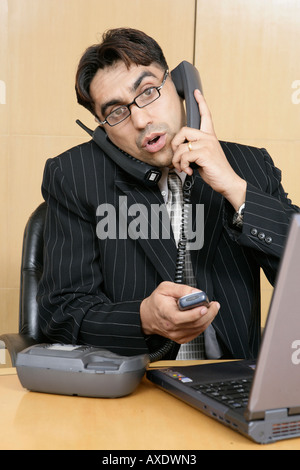 Portrait of a businessman talking on a telephone in a office Stock Photo