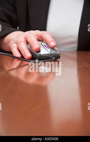 Businesswoman using computer mouse Stock Photo