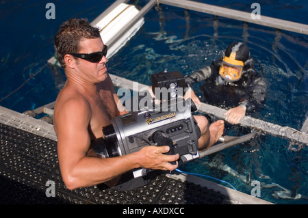 Underwater cameraman entering shark cage, Guadalupe Island Mexico Stock Photo