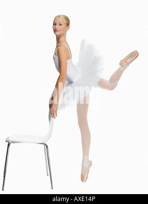 Young ballerina (14-15) standing pointe in toe shoes, portrait Stock Photo