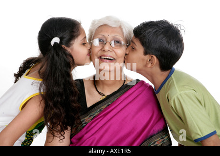 Grandchildren kissing there grandmother